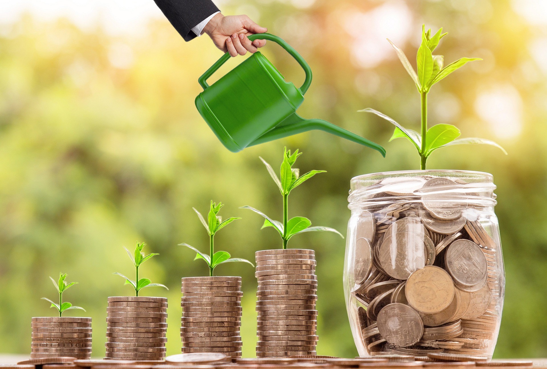Coins in increasingly higher stacks and a money jar with plants growing on top of coins and a mans hand with watering can.